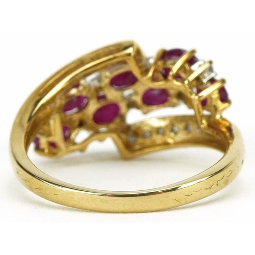 3185 - 9ct gold ruby and diamond crossover cluster ring, total diamond weight approximately 0.18 carat, tot... 