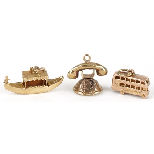 3216 - Three 9ct gold charms comprising vintage dial telephone, gondola and bus, the largest 2.2cm wide, to... 