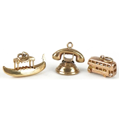 3216 - Three 9ct gold charms comprising vintage dial telephone, gondola and bus, the largest 2.2cm wide, to... 