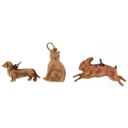 3217 - Three 9ct gold animal charms comprising hare, Dachshund and seated cat, the largest 2.9cm in length,... 