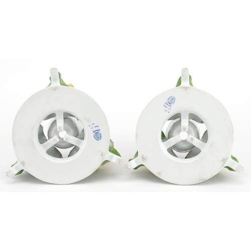 635 - Herend, pair of Hungarian floral encrusted porcelain candlesticks, each 13.5cm in diameter