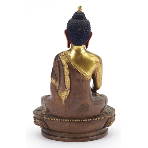 313 - Chino Tibetan partially gilt bronze figure of seated Buddha, 20cm high