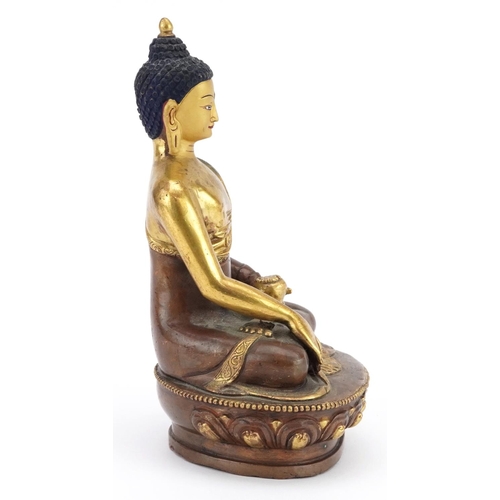 313 - Chino Tibetan partially gilt bronze figure of seated Buddha, 20cm high