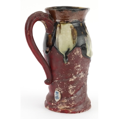 329 - Japanese Sumida Gawa figural jug with dragon handle, 19cm high