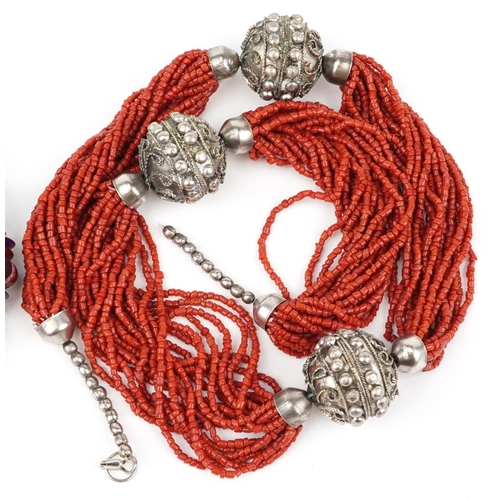 3803 - Two Middle Eastern necklaces, one coral and white metal, the other set with semi precious stones inc... 