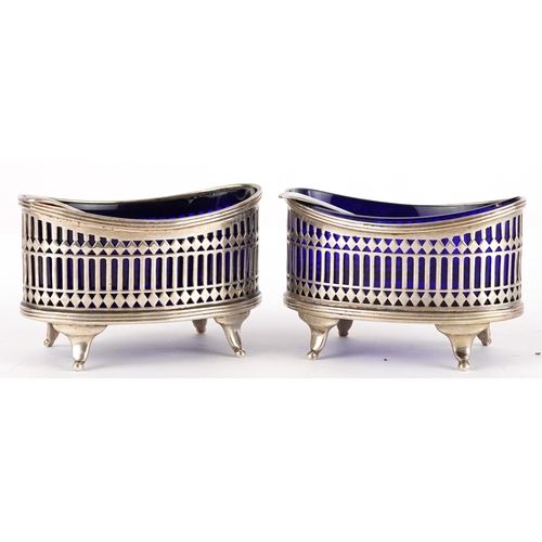 142 - Stokes & Ireland Ltd, pair of Edwardian pierced silver table salts with blue glass liners and two un... 