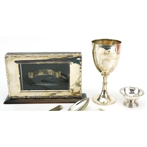 295 - Georgian and later silver including desk calendar frame, trophy and tablespoons, the largest 21cm wi... 