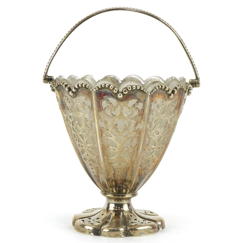 53 - Henry Wilkinson & Co, Victorian silver pedestal basket pierced with foliage, with swing handle and f... 