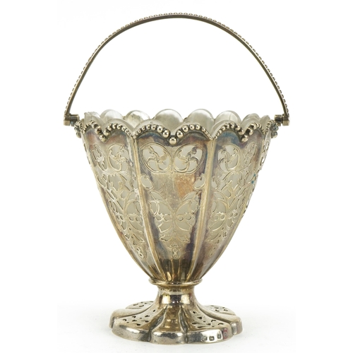 53 - Henry Wilkinson & Co, Victorian silver pedestal basket pierced with foliage, with swing handle and f... 