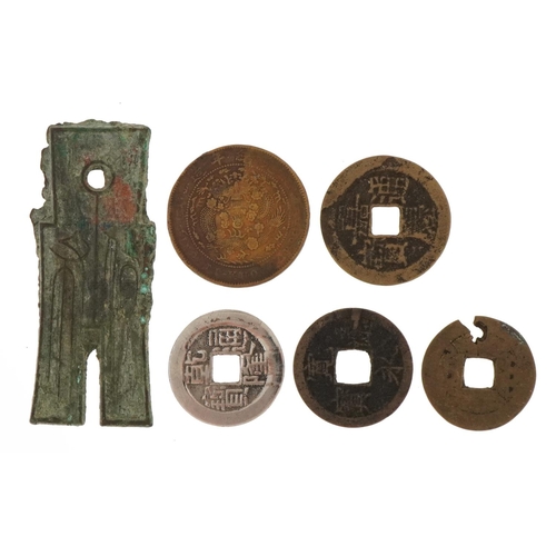 16 - Six antique Chinese coins and spade money including four cash coins, the largest 6cm in length