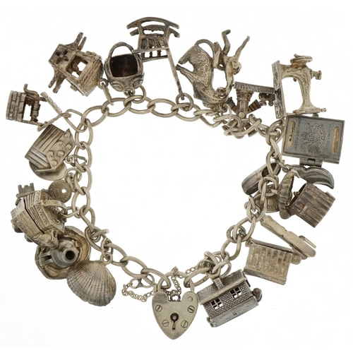 3203 - Silver charm bracelet with a selection of mostly silver charms including opening accordion, opening ... 