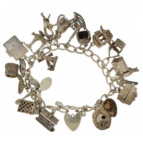 3203 - Silver charm bracelet with a selection of mostly silver charms including opening accordion, opening ... 