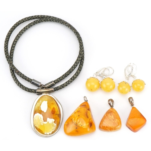 3809 - Amber jewellery comprising two pendants, one on chain and four pairs of earrings