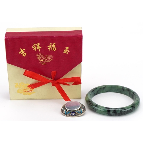 3798 - Chinese green jade bangle and silver and enamel brooch, the bangle 7cm in diameter