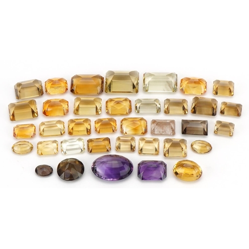 3823 - Loose semi precious stones including citrine, smoky quartz and amethyst, the largest 3cm in length