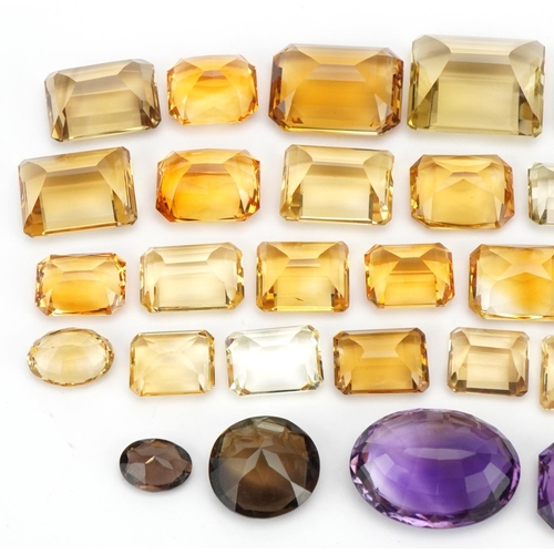 3823 - Loose semi precious stones including citrine, smoky quartz and amethyst, the largest 3cm in length