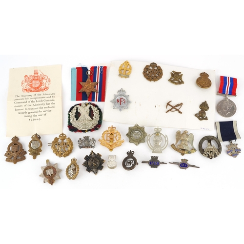 1259 - British military World War II medals, cap badges and sweetheart brooches including box of issue insc... 