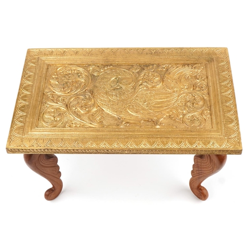 227 - Indian gilt painted occasional table carved with a stylised bird amongst foliage, 28.5cm H x 47.5cm ... 