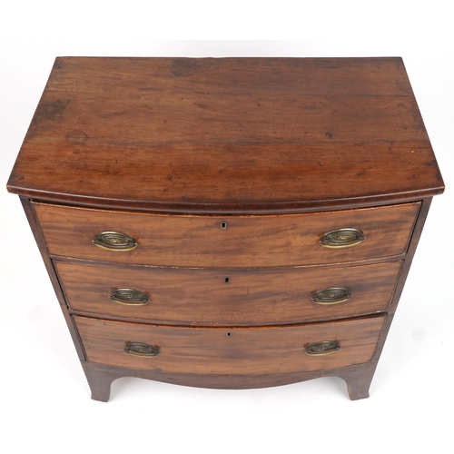 1016 - Georgian mahogany bow front three drawer chest with brass handles, 87cm H x 80cm W x 46cm D