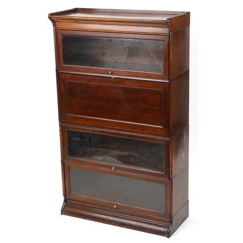 1011 - 19th/20th century Globe Wernicke oak four section bookcase on stand with fall enclosing pigeon holes... 