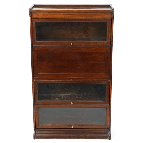 1011 - 19th/20th century Globe Wernicke oak four section bookcase on stand with fall enclosing pigeon holes... 