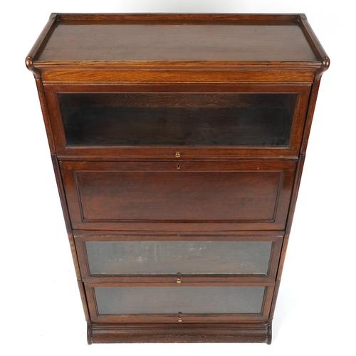 1011 - 19th/20th century Globe Wernicke oak four section bookcase on stand with fall enclosing pigeon holes... 