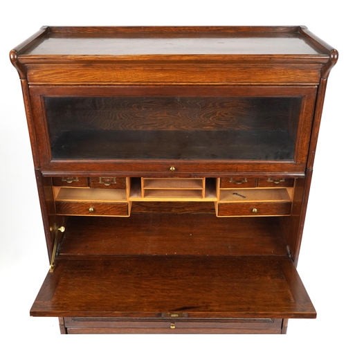 1011 - 19th/20th century Globe Wernicke oak four section bookcase on stand with fall enclosing pigeon holes... 