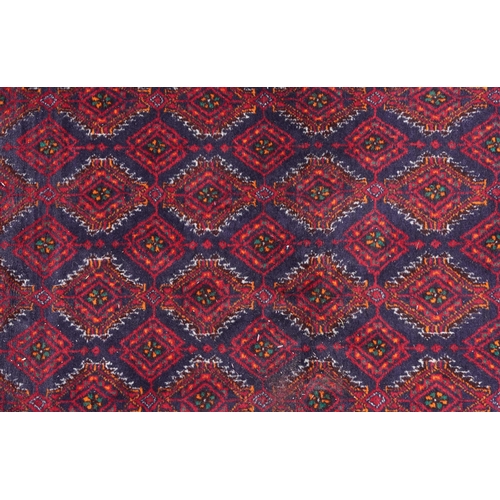 1015 - Rectangular Persian red ground rug having an allover repeat design within a geometric border, 190cm ... 