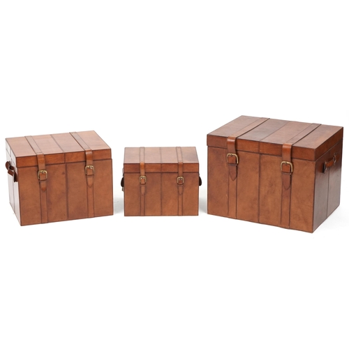 1004 - Graduated set of three brown leather trunks, the largest 46cm H x 61cm W x 46cm D