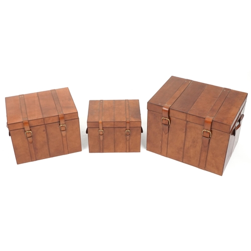 1004 - Graduated set of three brown leather trunks, the largest 46cm H x 61cm W x 46cm D