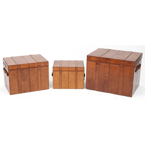 1004 - Graduated set of three brown leather trunks, the largest 46cm H x 61cm W x 46cm D