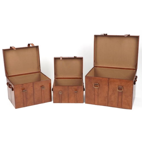 1004 - Graduated set of three brown leather trunks, the largest 46cm H x 61cm W x 46cm D