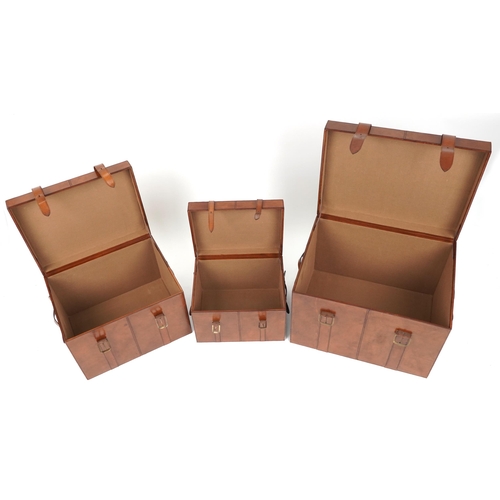 1004 - Graduated set of three brown leather trunks, the largest 46cm H x 61cm W x 46cm D