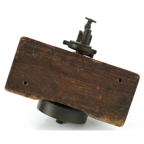 334 - Early 20th century steam interest piston on wooden block base, 18.5cm wide