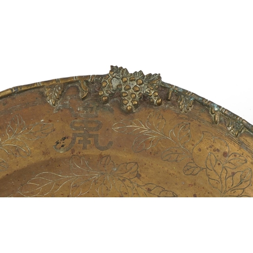 315 - Large Chinese patinated bronze charger engraved with dragons amongst fruit and flowers, 58cm in diam... 