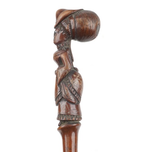 182 - Folk art carved walking stick of a lady with bustle, bouffant hair design and with beaded glass eyes... 