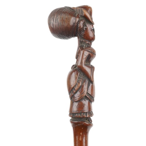 182 - Folk art carved walking stick of a lady with bustle, bouffant hair design and with beaded glass eyes... 