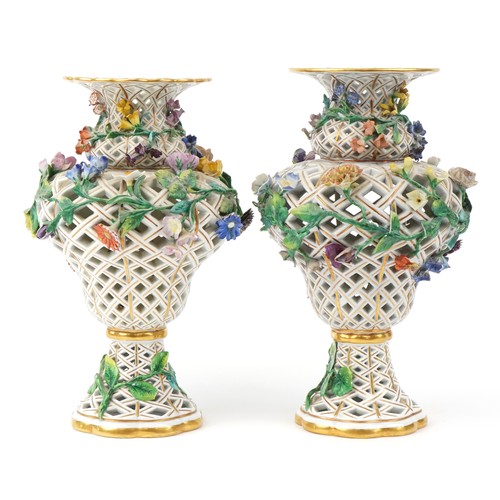 273 - Meissen, a near pair of large German reticulated porcelain floral encrusted vases, blue crossed swor... 