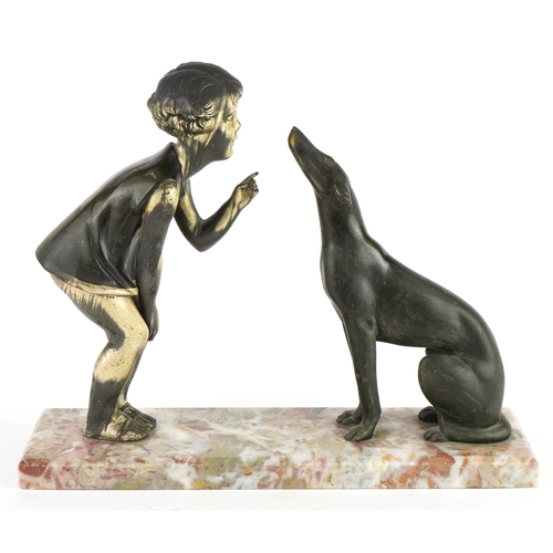 392 - Art Deco spelter young child with dog mounted on a marble base, 33cm wide