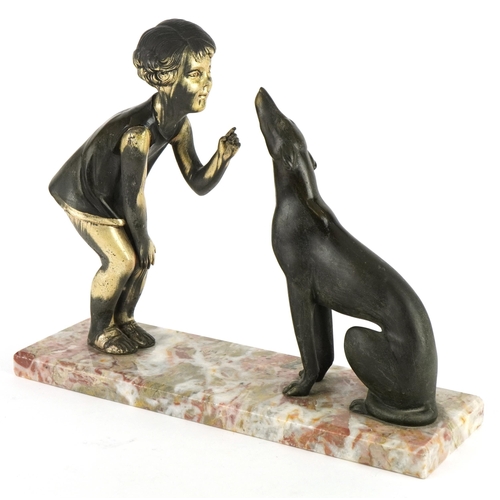 392 - Art Deco spelter young child with dog mounted on a marble base, 33cm wide