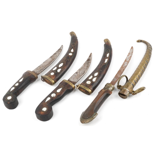 234 - Three Indian daggers including two with hardwood handles and sheaths having mother of pearl inlay, t... 