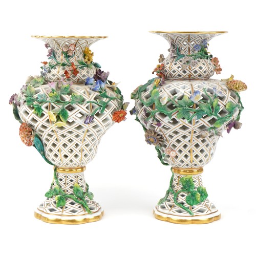 251 - Meissen, a near pair of large German reticulated porcelain floral encrusted vases, blue crossed swor... 