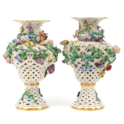 251 - Meissen, a near pair of large German reticulated porcelain floral encrusted vases, blue crossed swor... 