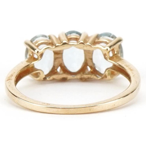 3204 - 10ct gold aquamarine three stone ring, the stones each approximately 7.00mm x 4.90mm x 3.40mm deep, ... 