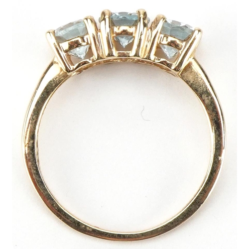 3204 - 10ct gold aquamarine three stone ring, the stones each approximately 7.00mm x 4.90mm x 3.40mm deep, ... 