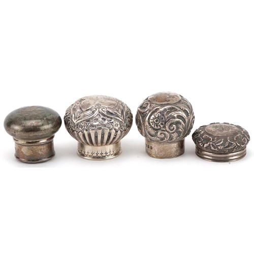 329 - Four silver scent bottle tops including floral examples, various hallmarks including London, the lar... 