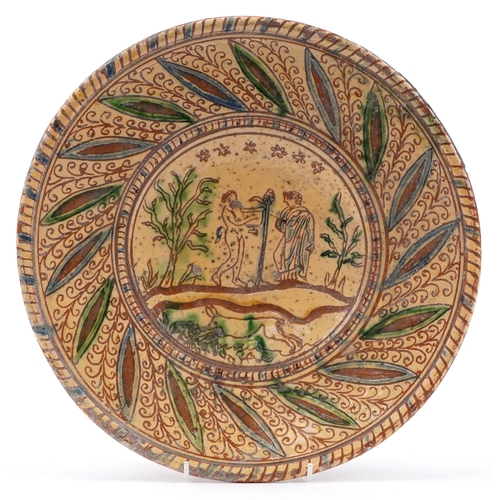 474 - 19th century earthenware plate with glazed Adam & Eve incised decoration, 34cm in diameter