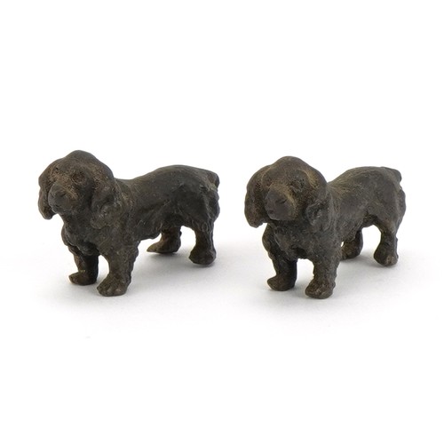 1429 - Pair of miniature patinated bronze Spaniels, each 3.5cm in length