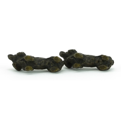 1429 - Pair of miniature patinated bronze Spaniels, each 3.5cm in length