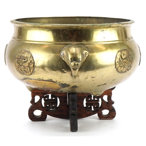 65 - Large Chinese bronze tripod censer with elephant head handles on hardwood stand with applied roundel... 